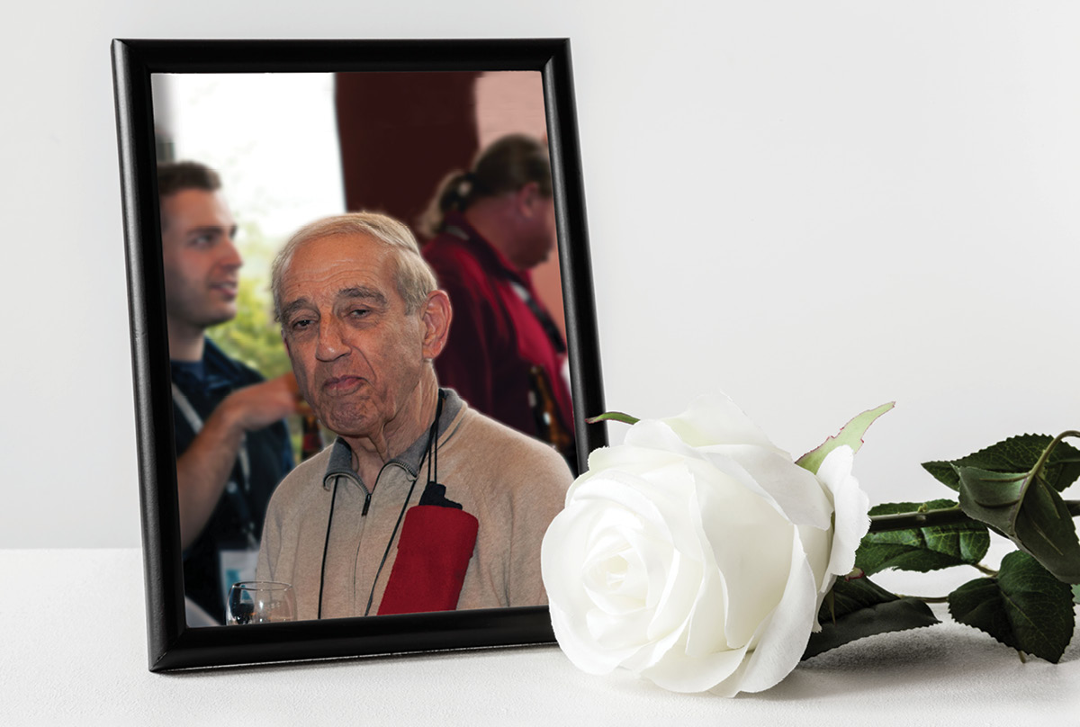 A framed photo of Nick Sion with a white rose in front