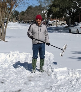 Scott attempts to clear his driveway with a broom