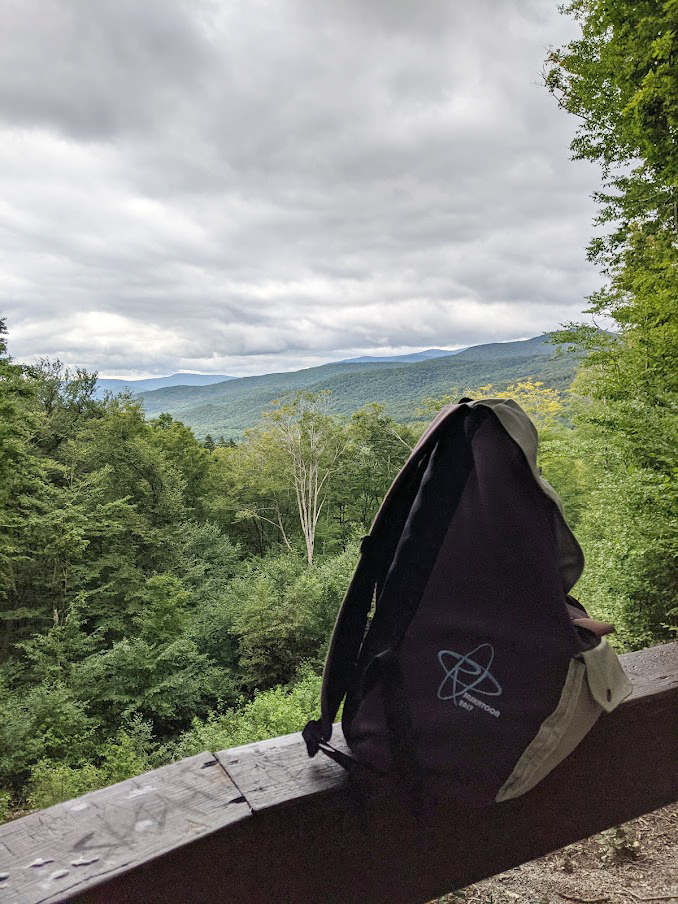 Sasky Pack sitting on a low wall overlooking the White Mountains.