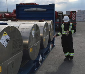 health physicist surveying a UN2977 package at a port
