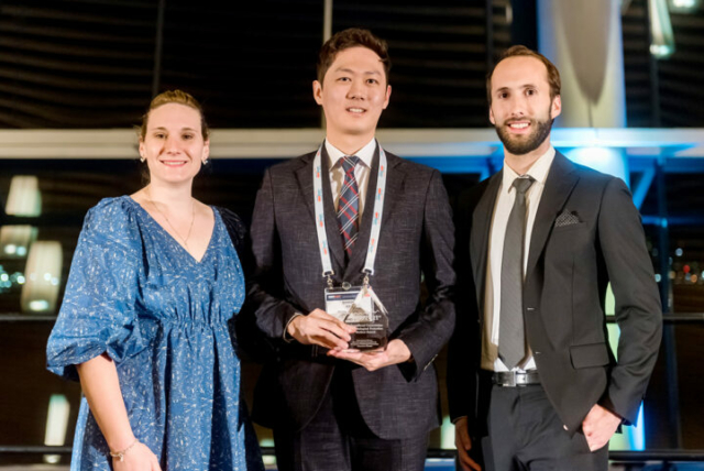 Leah Shuparski-Miller (left) and Matthew Bernacci (right) present the ICRP student contest trophy to Sihwan Kim (centre)