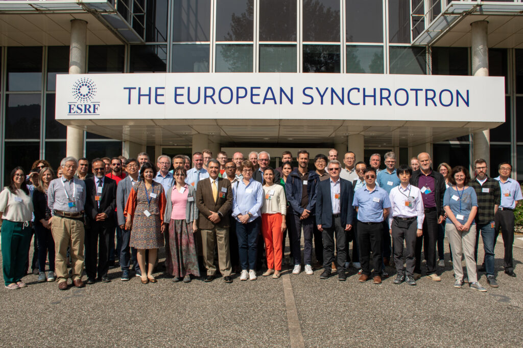 Photo of the participants at RadSynch23 standing in front of the European Synchrotron Radiation Facility.