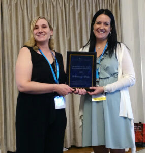 Leah Shuparski-Miller presenting the Meritorious Service Award to award to Jill Robertson