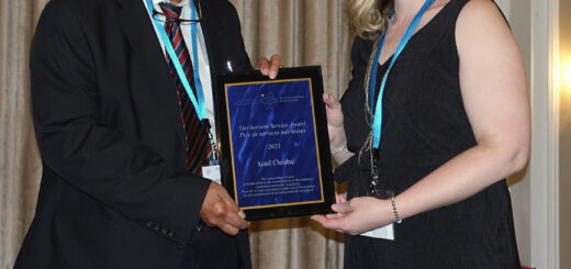 Leah Shuparski-Miller presenting the Meritorious Service Award to award to Sunil Choubal.