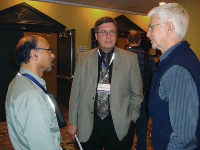 Jag Mohindra, Peter Fundarek, and Richard Osborne at the CRPA conference in Edmonton, AB, in 2010. Three men stand together talking in a reception room