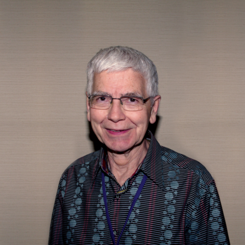 Richard Osborne as pictured on the cover of the Bulletin in 2016. a grey haired man with glasses wearing a dark button-up shirt